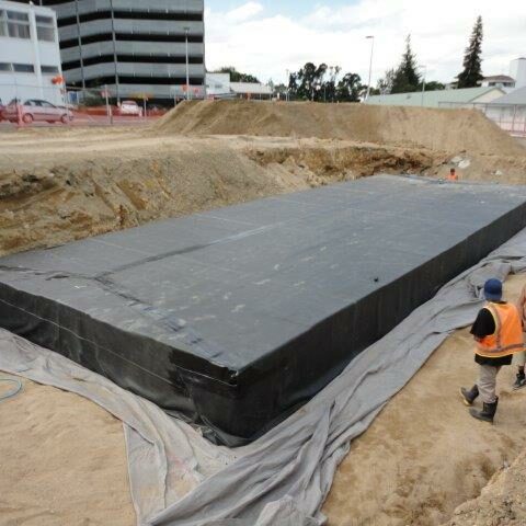 Impermeable liner wrapped around stormwater detention tank