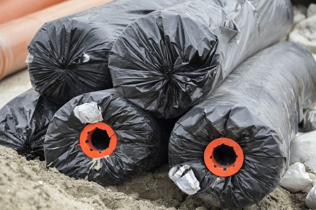 Black non woven geotextile rolls sitting on jobsite